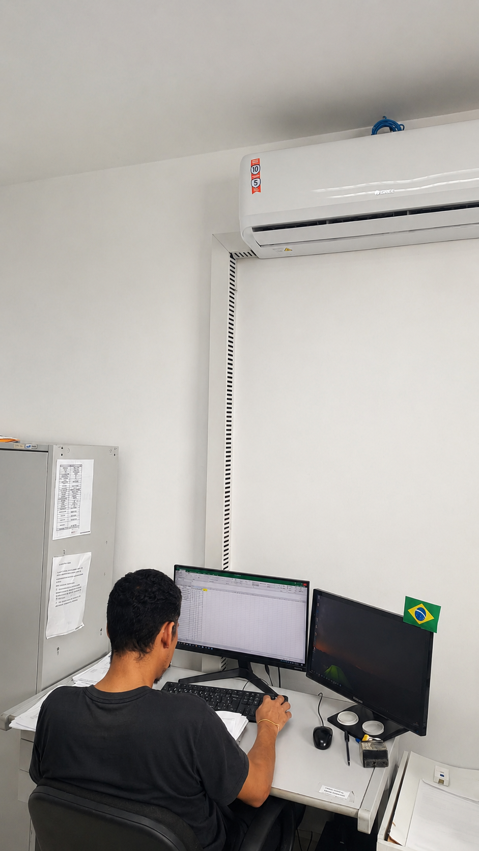 Profissional verificando a operação de climatização em ambiente corporativo
